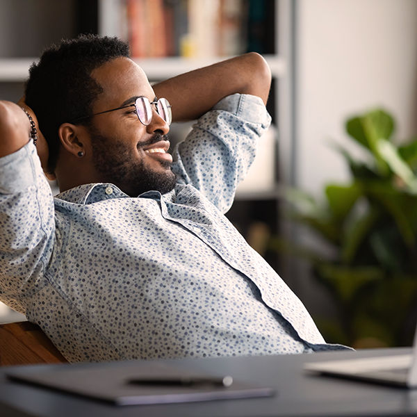 A relaxed male employee because he knows he is in control of his documents.